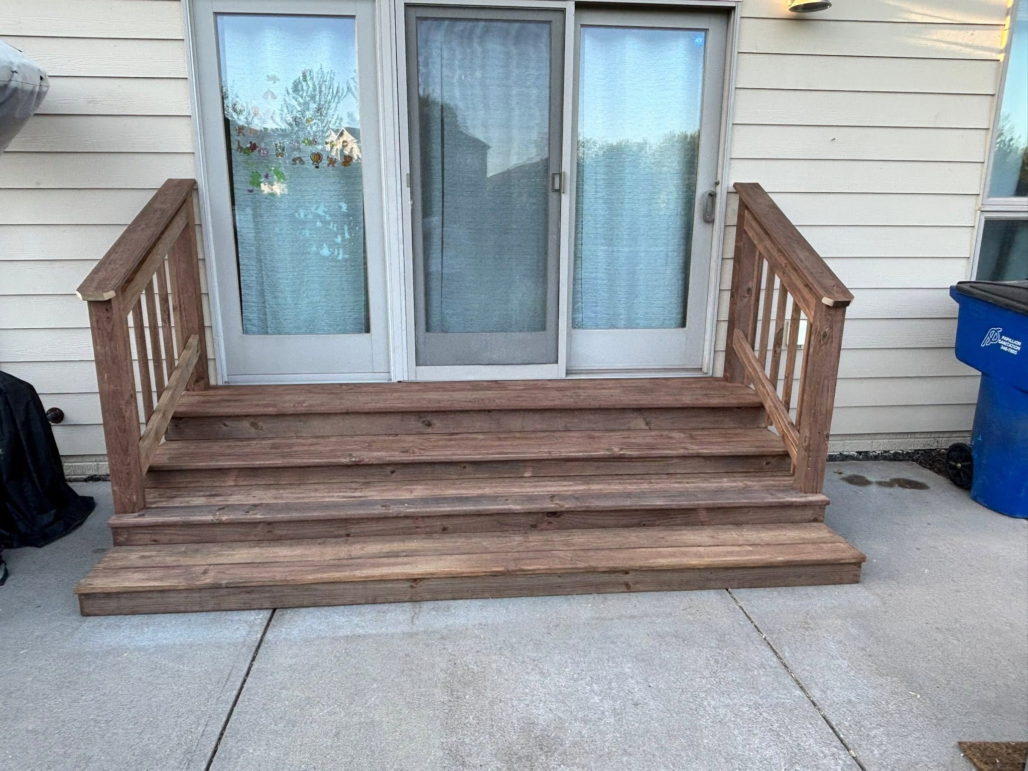 After: new wood deck with stairs and railings