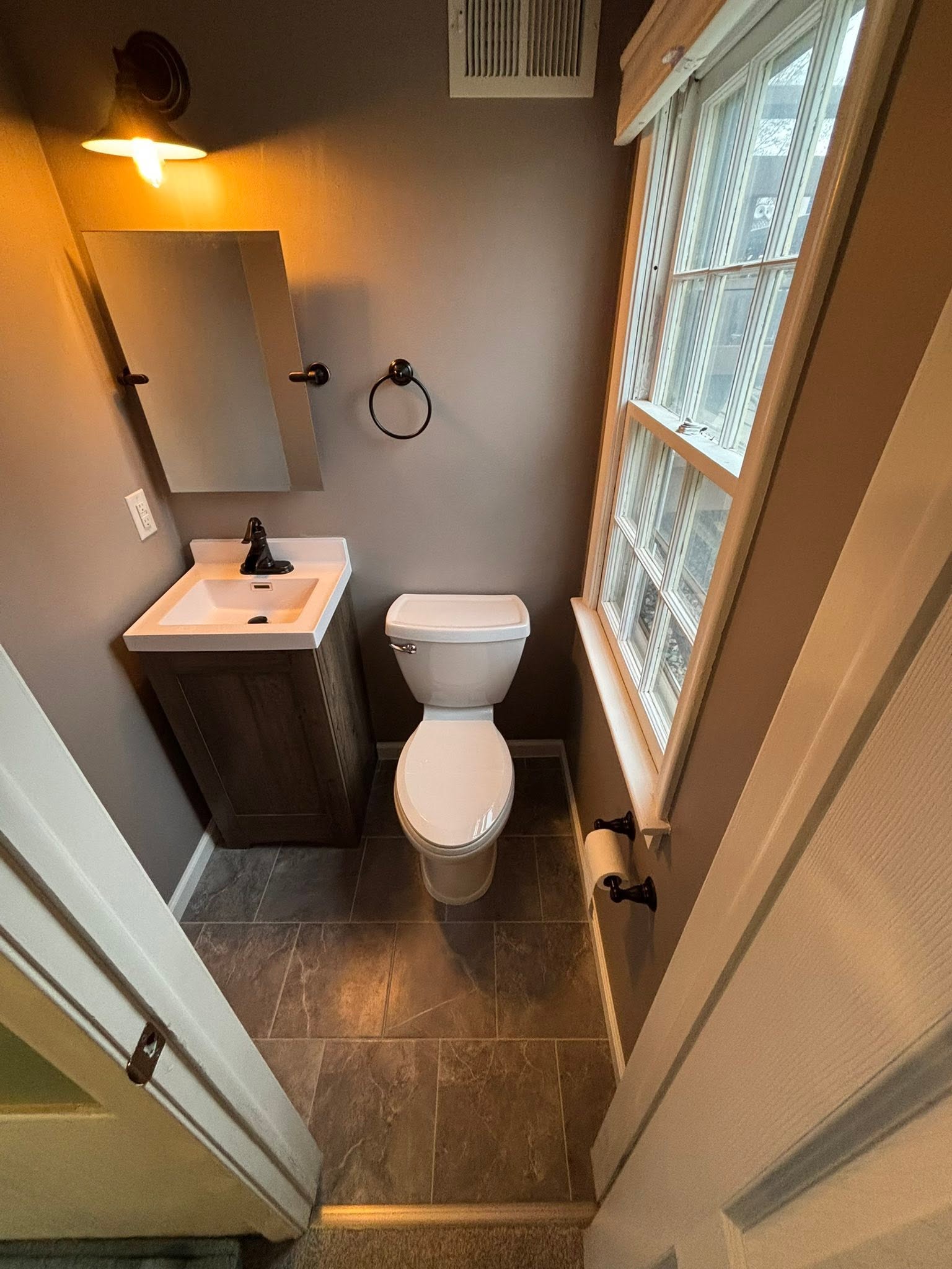 Half bathroom refresh with new vanity, tile floor, and updated fixtures
